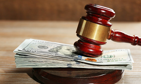 Law gavel with dollars on wooden table background, closeup